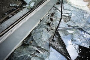 Accident cracked damaged broken shopping mall window glass.